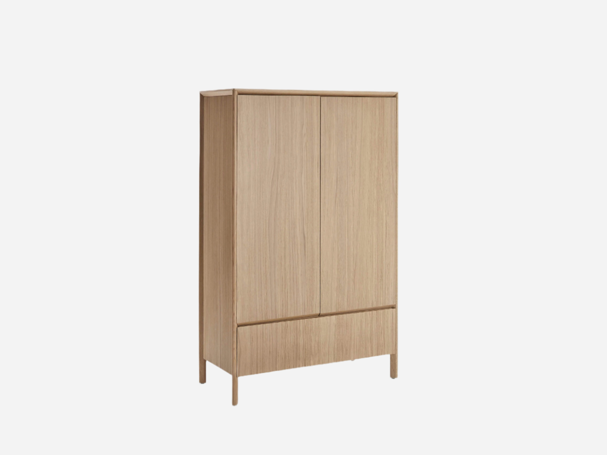 A tall, light wood wardrobe with two doors and a single drawer at the bottom, standing on four legs against a plain white background.