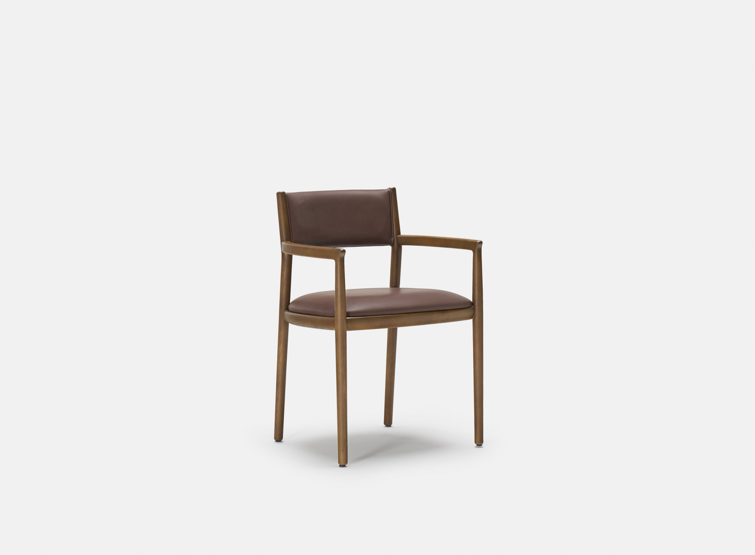 A wooden chair with a brown leather seat and backrest, featuring armrests and simple, clean lines, is centered against a plain white background.