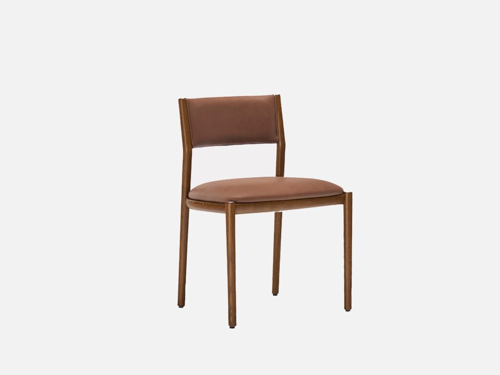 A modern wooden chair with a brown leather padded seat and backrest, featuring slim legs and a minimalist design against a plain white background.