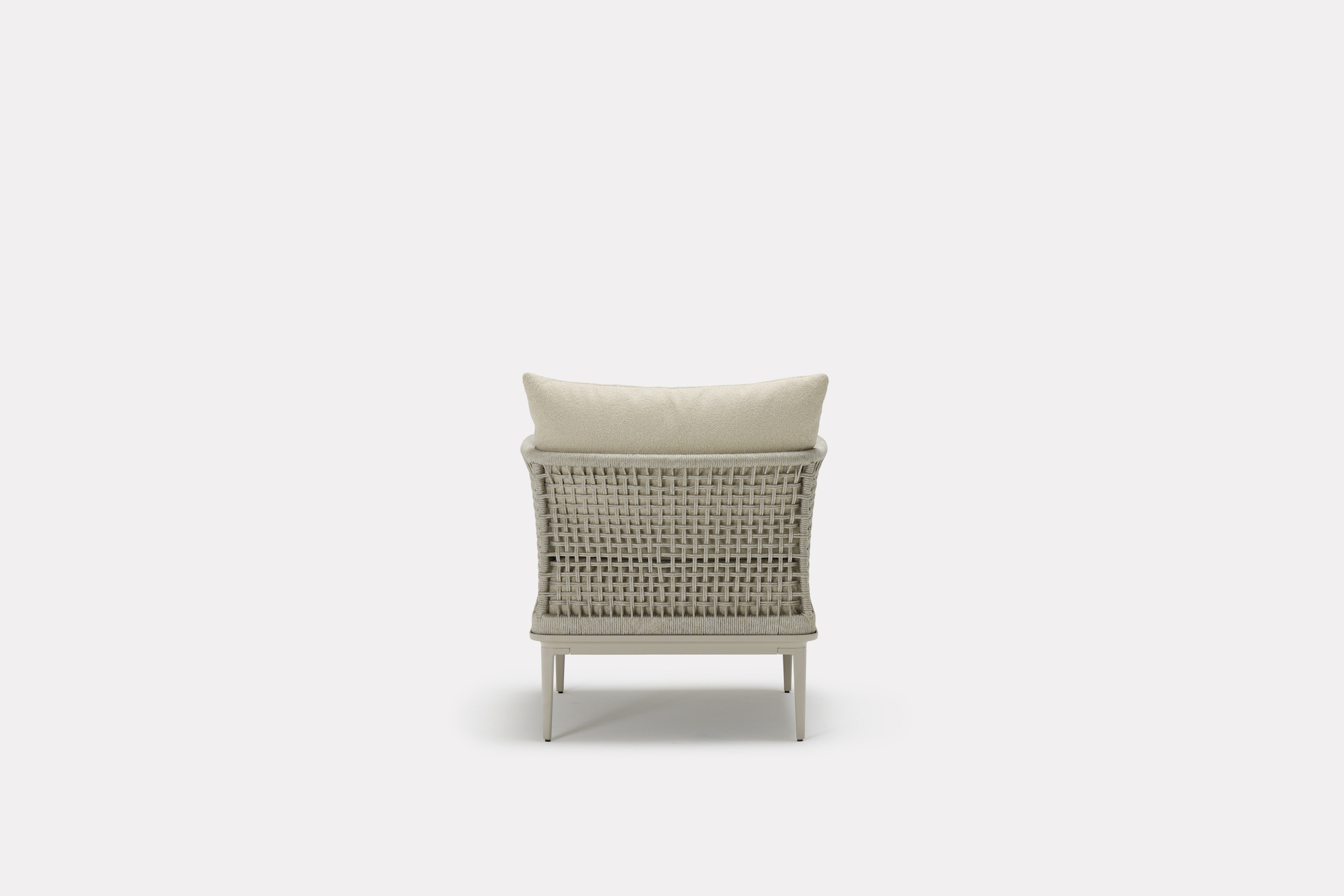 A modern armchair with a woven backrest, beige cushion, and slim metal legs, viewed from the back against a plain white background.