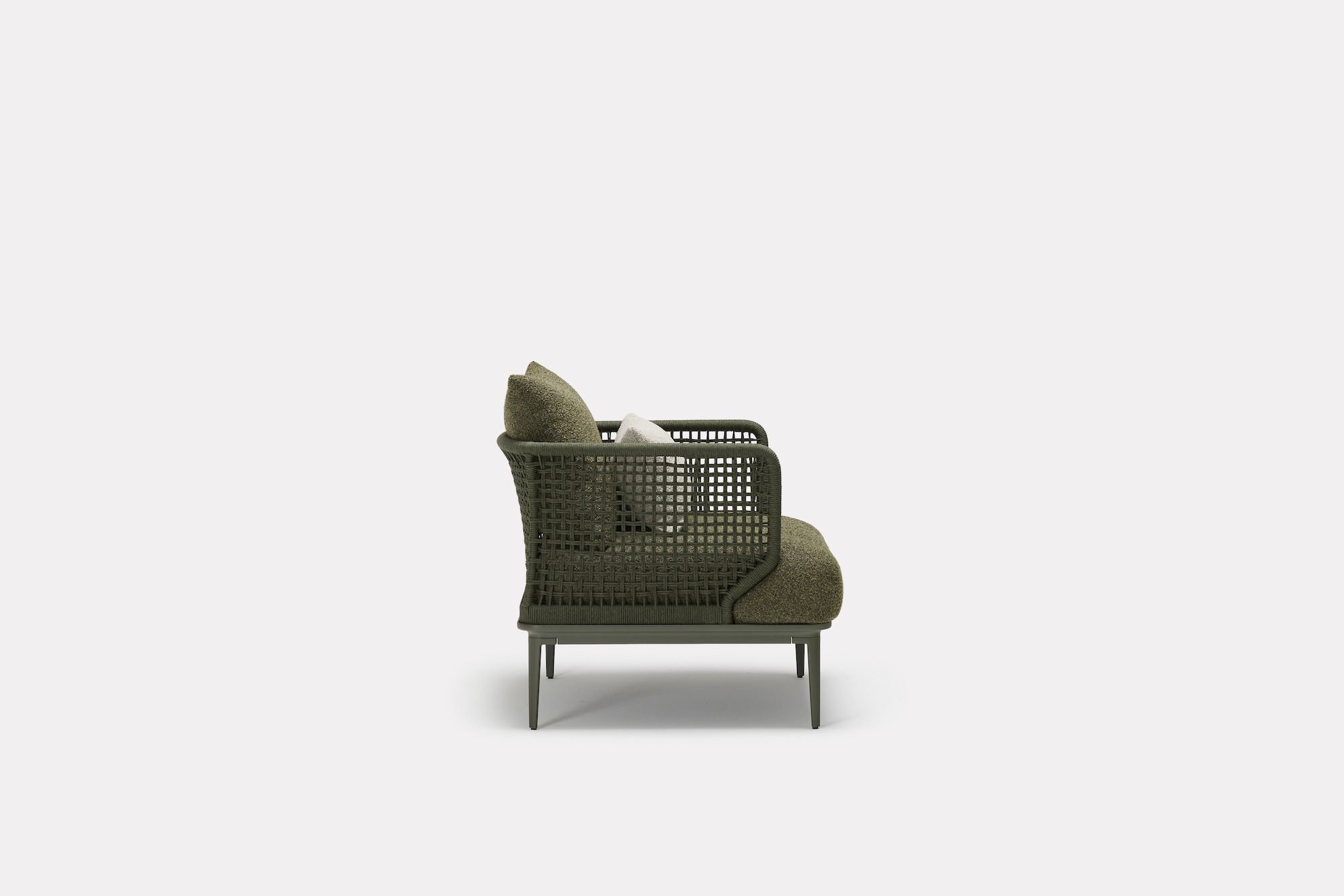 A modern green wicker armchair with metal legs, olive-green cushions, and a small light pillow, shown in profile view against a plain white background.