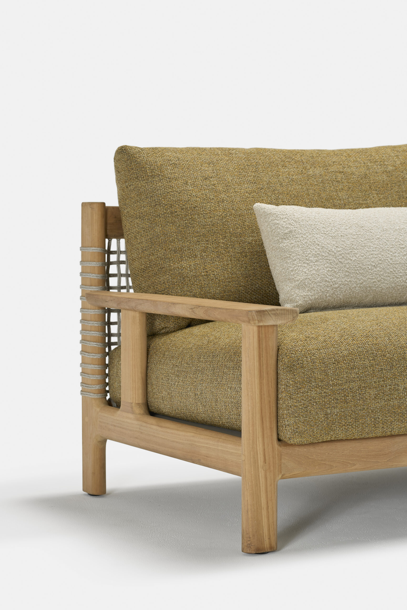 A modern wooden sofa with mustard-yellow fabric cushions, a light beige throw pillow, and woven rope detail on the armrest, shown against a plain white background.