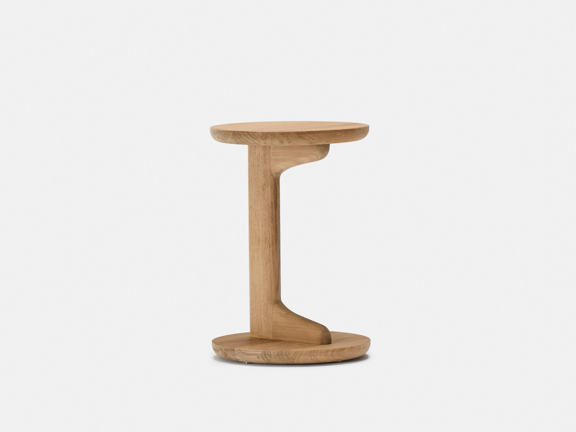 A small, round wooden side table with a unique, sculptural support connecting the top and base, both of which are circular. The table has a natural wood finish and minimalist design, set against a plain white background.
